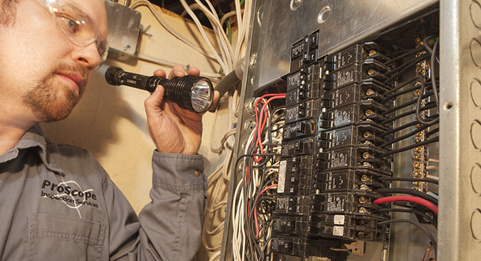 home inspector inspecting a panel in Camrose