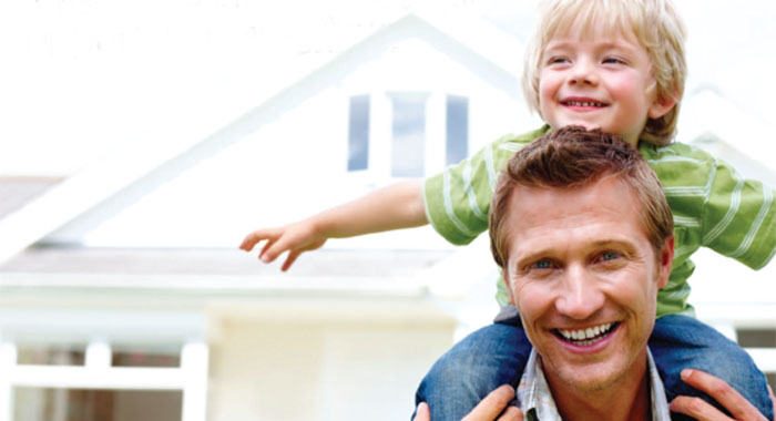 family in front of home